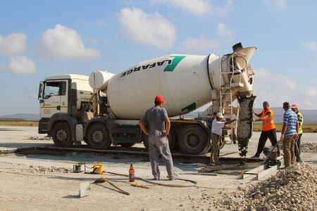 TULCEA, ROMANIA - SEPTEMBER 26: Cement truck pouring cement into a runway construction as part of the Danube Delta international airport expansion plan on September 26,2015 in Tulcea, Romania.のeditorial素材