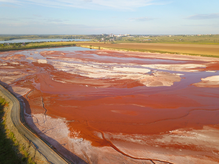 Aerial view of a reservoir full of red toxic sludgeの写真素材