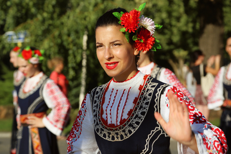 TULCEA, ROMANIA - AUGUST 08: Bulgarian dancer in traditional costume at the International Folklore Festival for Children and Youth - Golden Fish on August 08, 2018 in Tulcea, Romania.のeditorial素材