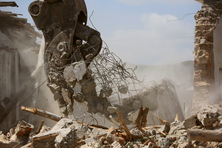 Tracked excavator demolishing old buildingsの写真素材