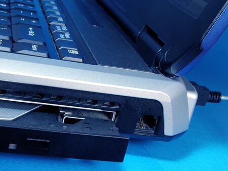 Close up of an open CD device and a computer...の写真素材