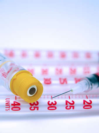 Composition with a syringe needle, syringes divisions and an insulin flask cap.The focus is on the...