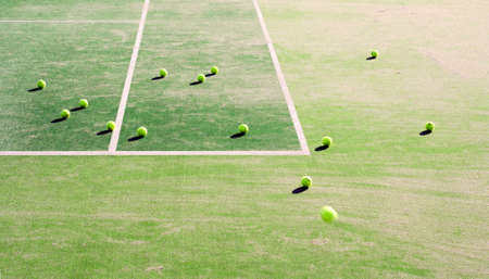Abstract image of tennis court and balls during a training session.Useful for a sports magazine or to enhance a design about a healthy lifestyle.の写真素材