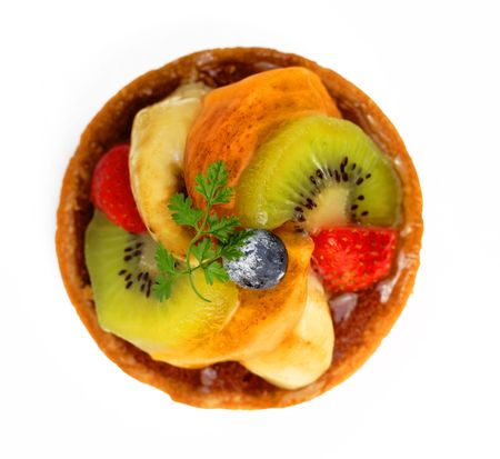 Upper view of a small tasty fruits tart over white backgroundの写真素材