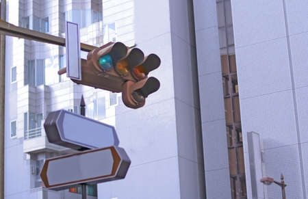 View of a traffic light in a downtown intersection.Selective focus on the green.の写真素材