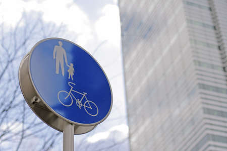 Pedestrian and bicycles route sign in a big city-selective focusの写真素材