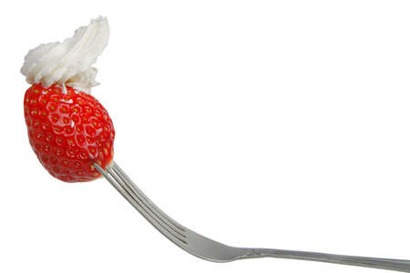 Strawberry with whipped cream in a fork isolated over white backgroundの写真素材