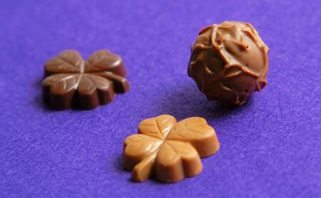 Fancy chocolates on a violet velvet background