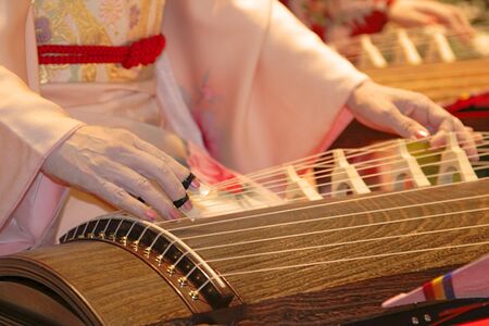 Detail of a geisha hand playing kato a traditional Japanese instrument.の写真素材
