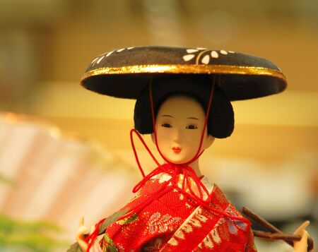 Geisha doll portrait in front of a souvenir store-location lighting and mood.の写真素材