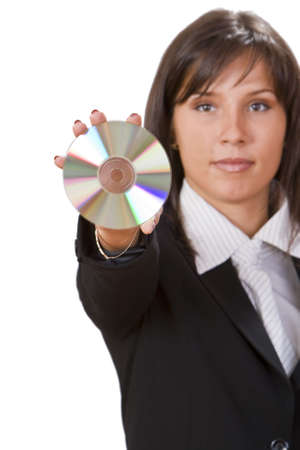 Woman offering a CD to the viewer.Focus on the CD,the woman is out of focus.の写真素材