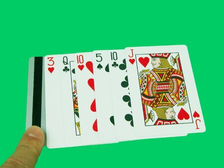 Finger pointing the credit card near playing cards.        のeditorial素材