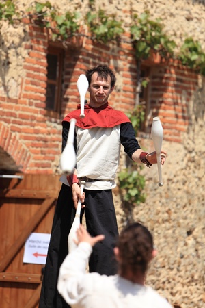 Arville,France,May 23rd 2010: Two skittles jugglers performing in the yard of the Commanderie of templars from Arville, during a Medieval Market show. Here is one of the best preserved Commanderie in France.のeditorial素材