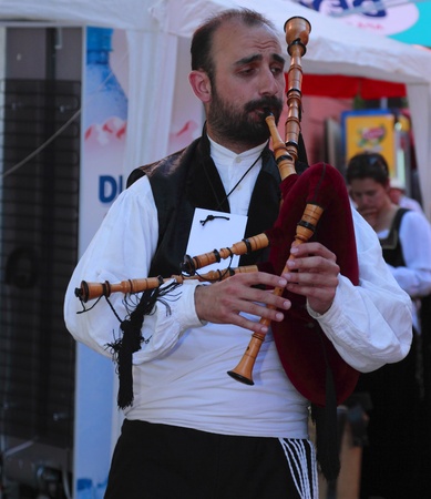 Sighisoara,Romania July 24th 2009:Bagpiper playing on the Sighisoara streets during Festival of Medieval Arts and Crafts from Sighisoara.のeditorial素材
