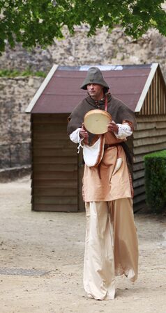 Nogent le Rotrou,France,May 15th 2010: Medieval troubadour on stilts walking with a tambourine のeditorial素材