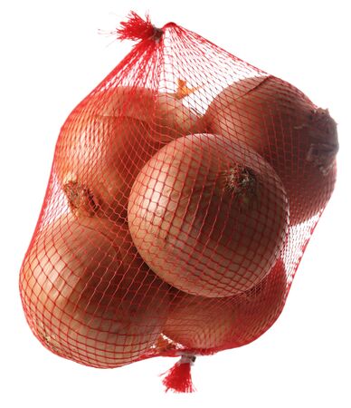 Onions in net against a white background.の写真素材