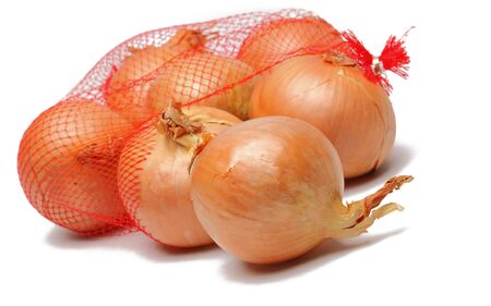 Image of onions getting out from a broken net bag, against a white background.の写真素材