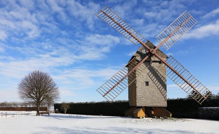 Countryside landscape with traditional windmill during the winter, located in the central part of France.の写真素材