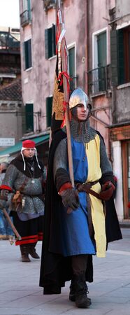 Venice,Italy,February 25th 2011: Young man disguised as a medieval standard bearer marching in a costumes parade on Sestiere Castello in Venice,during The Carnival days.The Carnival of Venice (Carnevale di Venezia) is an annual festival, held in Venice, Iのeditorial素材
