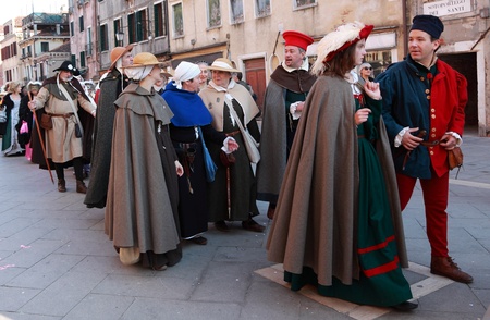 Venice, Italy- February 26th, 2011: People wearing specific medieval clothes participating in a costumes parade on Sestiere Castello during the Venice Carnival days. The Carnival of Venice (Carnevale di Venezia) is an annual festival, held in Venice, Italのeditorial素材