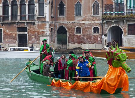 Venice,Italy- February 19, 2012: A decorated gondola with a group of disguised people on the Grand Canal in Venice during the Venice Carnival days.のeditorial素材