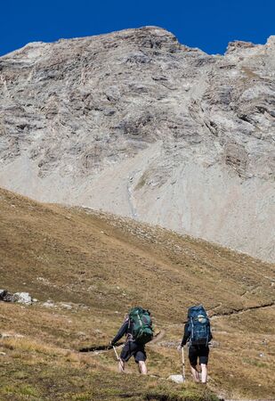 Col de La Cayolle, France,August 26, 2012: Image of two people hiking in The South Alps in France (Alpes de Haute Provence) close to mountain pass Cayolle.のeditorial素材