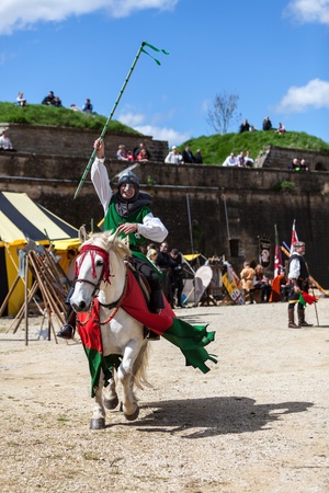 Montmedy, France, April 29th, 2012: Happy victorious knight riding his horse in a tournament during a medieval festival in Montmedy, France.のeditorial素材