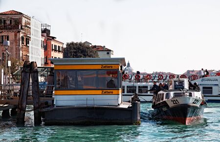Venice, Italy- February 26th, 2011: Image of a Vaporetto reaching the Zattere Station on The Grand Canal in Venice during the Carnival days. Vaporeto is a motorised waterbus which ply regular routes along the major canals and between the city's islands.のeditorial素材