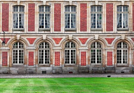 Fontainebleau, France- June 19, 2011: Detail of a wall with windows in the right part of the "Cour d'Honneur" of The Palace of Fontainebleau.This is one of the largest royal palace in France situated close to Paris near the famous Forest of Fontainebleau のeditorial素材