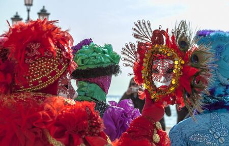 Venice, Italy- February 18th, 2012: Environmental portrait of a person in a traditional Venetian mask looking in a traditional mirror on Sestiere Castello during the Venice Carnival dyas.のeditorial素材