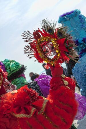 Venice, Italy- February 18th, 2012: Environmental portrait of a person in a traditional Venetian mask looking in a traditional mirror on Sestiere Castello during the Venice Carnival dyas.のeditorial素材