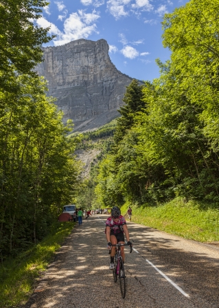 Col du Granier,France-July 13th, 2012: Amateur female cyclist climbing the road to mountain pass Granier before the passing of the peloton during the stage 12th of La Tour de France 2012.のeditorial素材