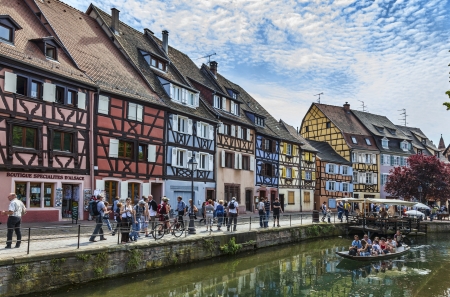 Colmar,France- April 23rd, 2011: Tourists walking on a traditional street near a canal in Colmar in Alsace,France.のeditorial素材