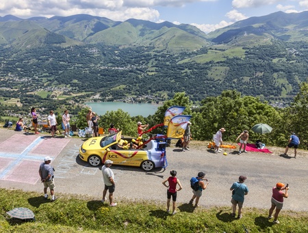 Col de Val Louron-Azet, France- July 07,2013  Yellow LCL car during the passing of the publicity caravan on the road to Col de Val Louron Azet in Pyrenees Mountains during the stage 9 of the 100 edition of Le Tour de France in 2013 のeditorial素材