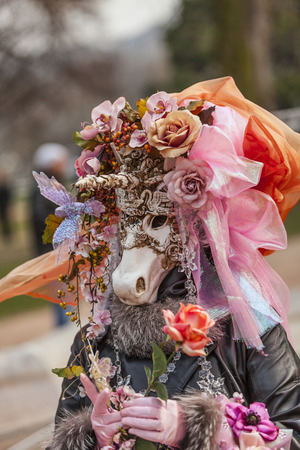 Annecy,France-March 15,2014 Environmental portrait of a person wearing a fancy unicorn disguise during the Annecy Venetian Carnival  Yearly in Annecy ,France is held a Venetian Carnival to celebrate the beauty of the real Venice のeditorial素材