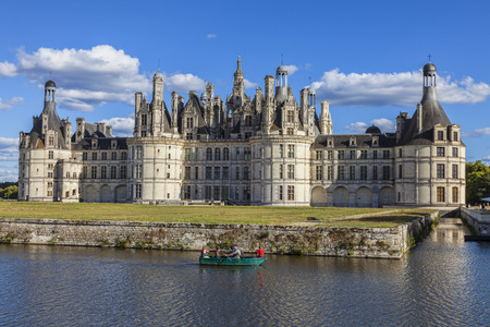 Chambord,France-September 08,2013  A family rowing in a green boat on a canal in front of the Chambord Castle  Chambord is royal medieval French castle in Loire Valley - UNESCO heritage site のeditorial素材