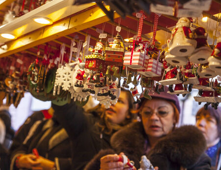Colmar,France- December 06, 2013: Women looking to ornaments at a kiosk during the Christmas Market in Colmar,Alsace,France.のeditorial素材