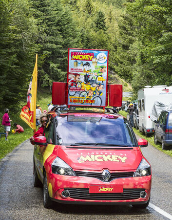 Col de Platzerwasel, France - July 14, 2014:Image of the car advertising the magazine \"Le Journal du Mickey\" during the passing of the publicity caravan on the road to Mountain Pass Platzerwasel, in Vosges mountains, during the stage 10 of Le Tour de Frのeditorial素材