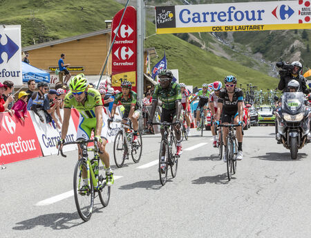 Col du Lautaret, France - July 19, 2014: The peloton arrives on Col du Lautaret in Hautes Alpes, during the stage 14 of Le Tour de France 2014.のeditorial素材