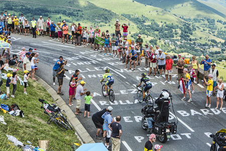 Col de Peyresourde,France- July 23, 2014: The cyclists Nicolas Roche ( Team Tinkoff-Saxo ) and Jesus Herrada Lopez (MovistarTeam) climbing the road to Col de Peyresourde in Pyrenees Mountains during the stage 17 of Le Tour de France on 23 July 2014.のeditorial素材