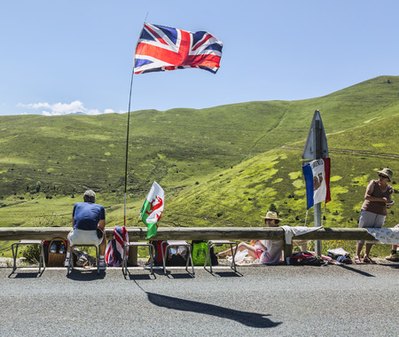 Col de Peyresourde,France- July 23, 2014: A spectator waits for the peloton few hours before the race on the road to Col de Peyresourde in Pyrenees Mountains during the stage 17 of Le Tour de France on 23 July 2014.のeditorial素材