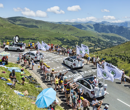 Col de Peyresourde,France- July 23, 2014: Skoda caravan on the road to Col de Peyresourde in Pyrenees Mountains in front of excited spectators, during the passing of the Publicity Caravan in the stage 17 of Le Tour de France on 23 July 2014.Skoda providesのeditorial素材
