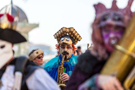 Venice,Italy,February 26th 2011: Portrait of a funny man saxophone player during a musical parade in...