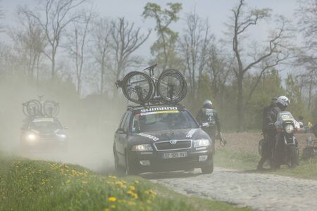 Carrefour de l Arbre,France-April 13,2014: Row of technical vehicles transportin bicycles on the...