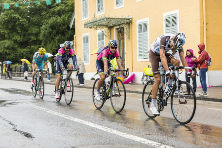 Gerardmer France  12.07.2014: A group of four cyclists riding during a rainy day in the stage 8 of Le Tour de France 2014 in Gerardmer.のeditorial素材