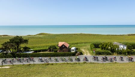 Sainte Marguerite sur Mer, France - 09 July 2015: The peloton riding near the beach in Normandy during the stage 6 of Le Tour de France 2015 on 09 July 2015.のeditorial素材