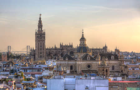 Image at the sunset of the great Cathedral of Seville in Andalusia, Spain. This is a symbolic landmark of Seville and the authorities prohibit any other building in the center of the Andalusian capital to reach its height.の写真素材