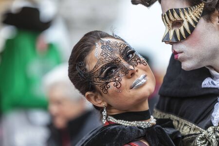 Venice,Italy- March 2, 2014: Portrait of a couple with Colombina masks and specific make-ups, posing in San Marco Square during the Venice Carnival days.のeditorial素材