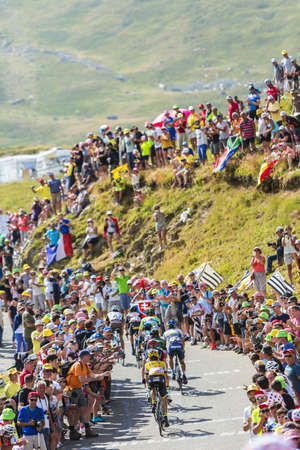 Col du Glandon, France - July 23, 2015: Group of cyclists riding on the road to Col du Glandon in Alps during the stage 18 of Le Tour de France 2015.のeditorial素材