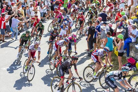 Col du Glandon, France - 23 July 2015: The peloton riding on the road to Col du Glandon in Alps during the stage 18 of Le Tour de France 2015.のeditorial素材
